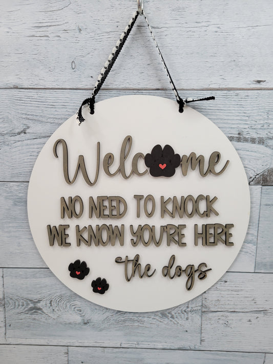 Welcome No need to knock. We know you're here. The Dogs. Door Hanger